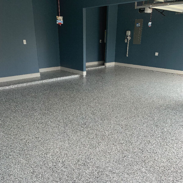 Durable Floor Shield application in a basement, showcasing aesthetic enhancements by Dry Otter Foundation Repair.