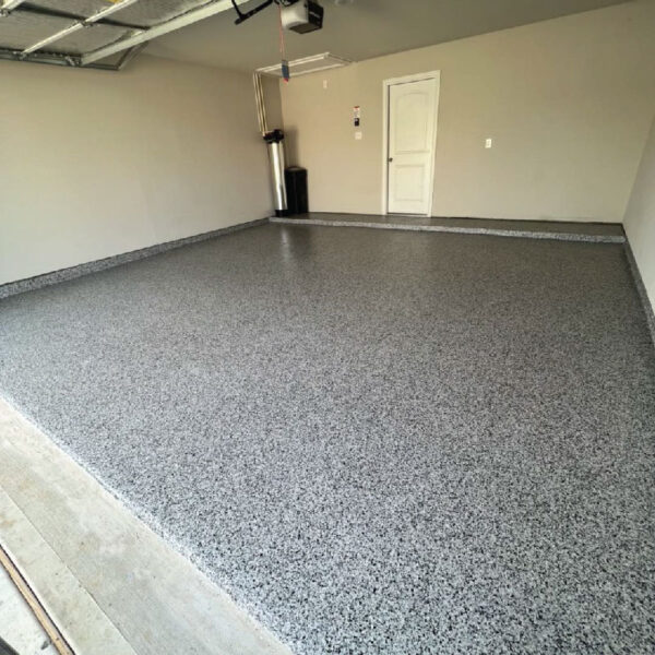 Completed Floor Shield project showcasing durable, visually appealing flooring in a basement by Dry Otter Waterproofing.