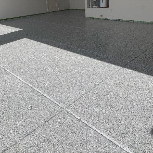 Completed Floor Shield project showcasing durable, aesthetic flooring in a basement by Dry Otter Waterproofing.