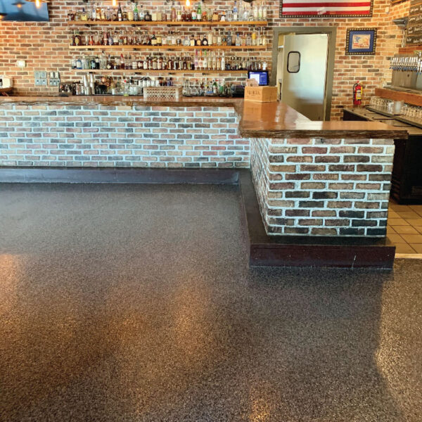 Durable Floor Shield application in a basement by Dry Otter, showcasing stylish and resilient flooring.